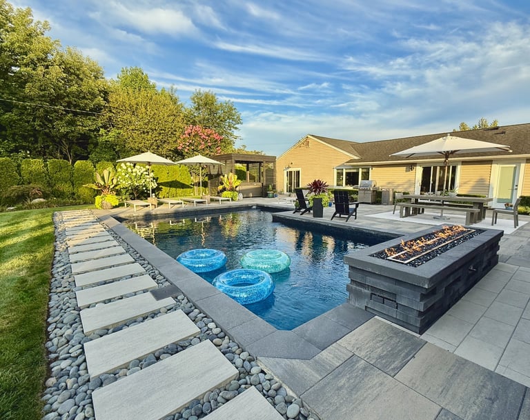 Luxurious backyard patio with outdoor seating, bar area and resort-style ambiance