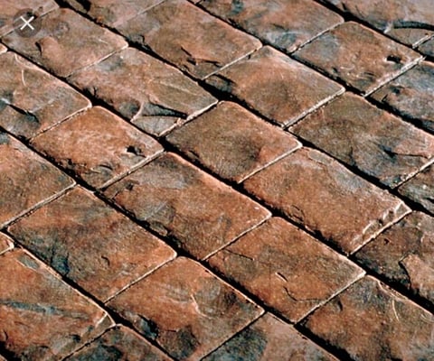 Close-up of weathered red and brown roof tiles arranged in overlapping rows