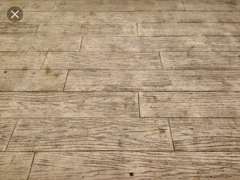 Close-up of light wood-look laminate flooring with staggered plank pattern and visible grain texture