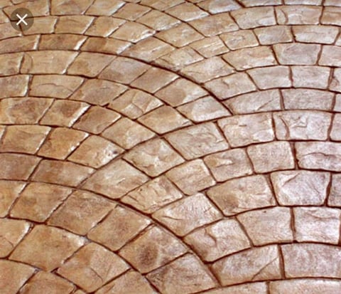 Close-up of curved terracotta brick paving pattern with geometric fan layout